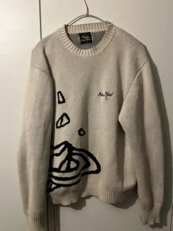 Beige stickad tröja med grafiskt tryck – stilren & unik